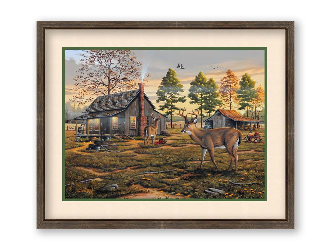 A painting of a farmhouse scene, featuring a fenced field, wood cabin, and an accompanying shed. In the foreground, deer are eating apples from wagons and baskets in the yard. Printed on paper, matted, and framed.