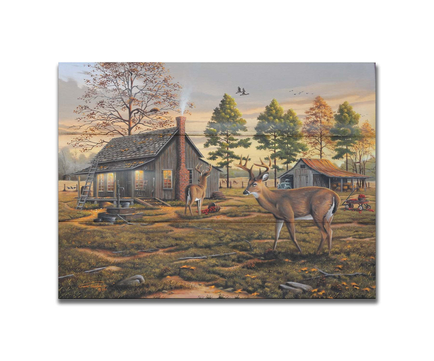 A painting of a farmhouse scene, featuring a fenced field, wood cabin, and an accompanying shed. In the foreground, deer are eating apples from wagons and baskets in the yard. Printed on a box board.