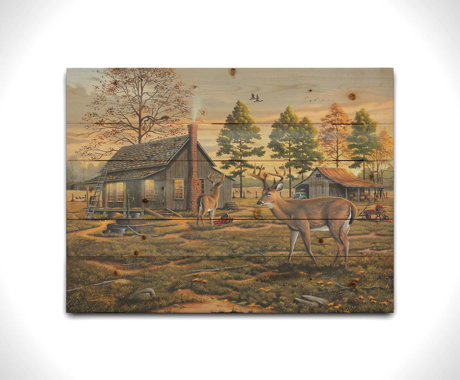 A painting of a farmhouse scene, featuring a fenced field, wood cabin, and an accompanying shed. In the foreground, deer are eating apples from wagons and baskets in the yard. Printed on a wood pallet.