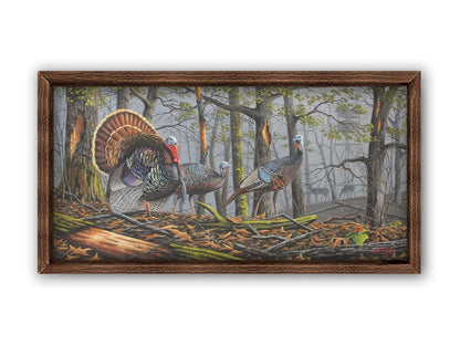 A painting of three turkeys walking through the woods on leaf-covered ground. In the distance, grazing deer and a hunting stand are visible through the fog. Printed on canvas and framed.