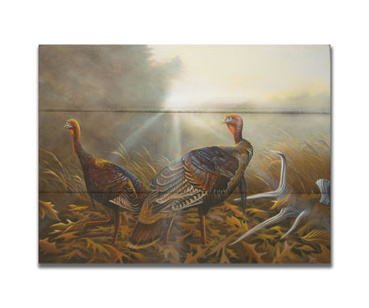 A portrait painting of two turkeys standing in a serene meadow, among fallen brown oak leaves and a shed deer antler. Printed on a box board.