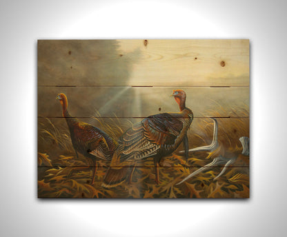 A portrait painting of two turkeys standing in a serene meadow, among fallen brown oak leaves and a shed deer antler. Printed on a wood pallet.