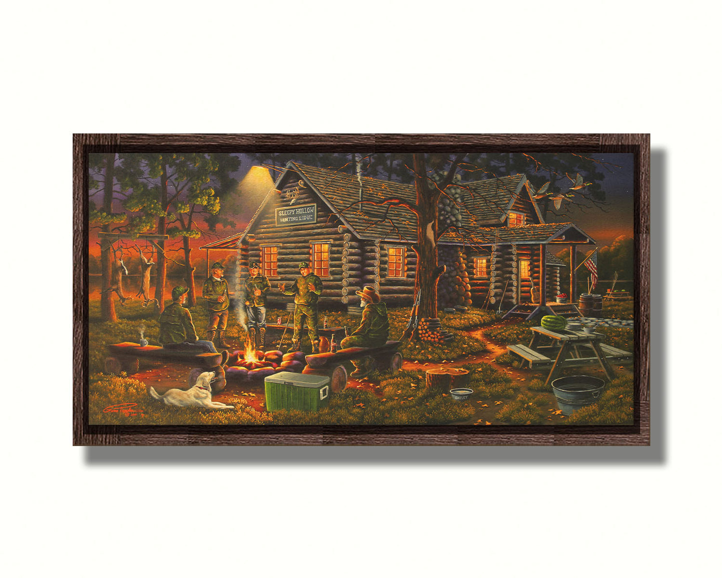 A painting of a group of hunters and their dog, gathered around a campfire at sunset. Behind them is a log cabin hunting lodge, and deer hang from skinning racks in the distance. Printed on canvas in a float frame.