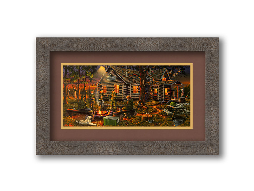 A painting of a group of hunters and their dog, gathered around a campfire at sunset. Behind them is a log cabin hunting lodge, and deer hang from skinning racks in the distance. Printed on paper, matted, and framed.