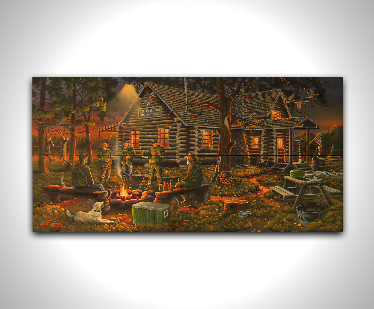 A painting of a group of hunters and their dog, gathered around a campfire at sunset. Behind them is a log cabin hunting lodge, and deer hang from skinning racks in the distance. Printed on a wood pallet.