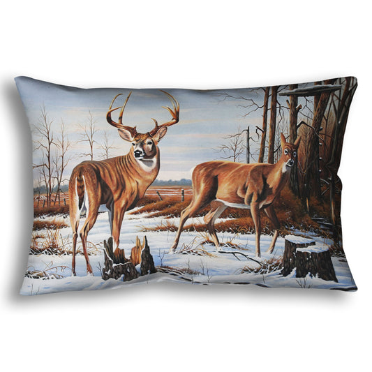 Decorative throw pillow designed with deer walking through the snow between the woods and a field.