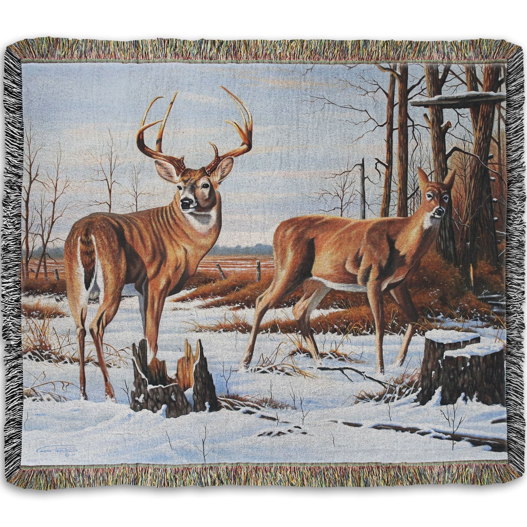 Woven throw blanket designed with deer walking through the snow between the woods and a field.