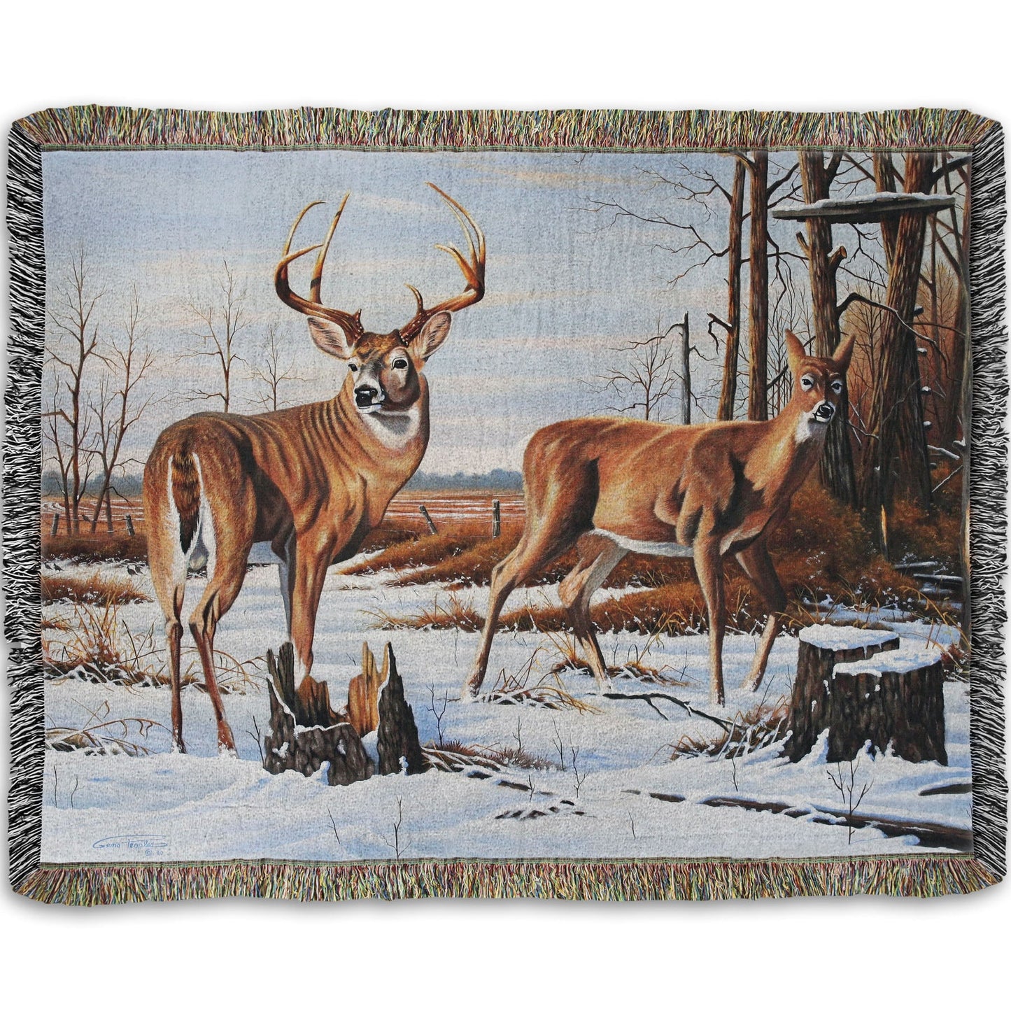 Woven throw blanket designed with deer walking through the snow between the woods and a field.