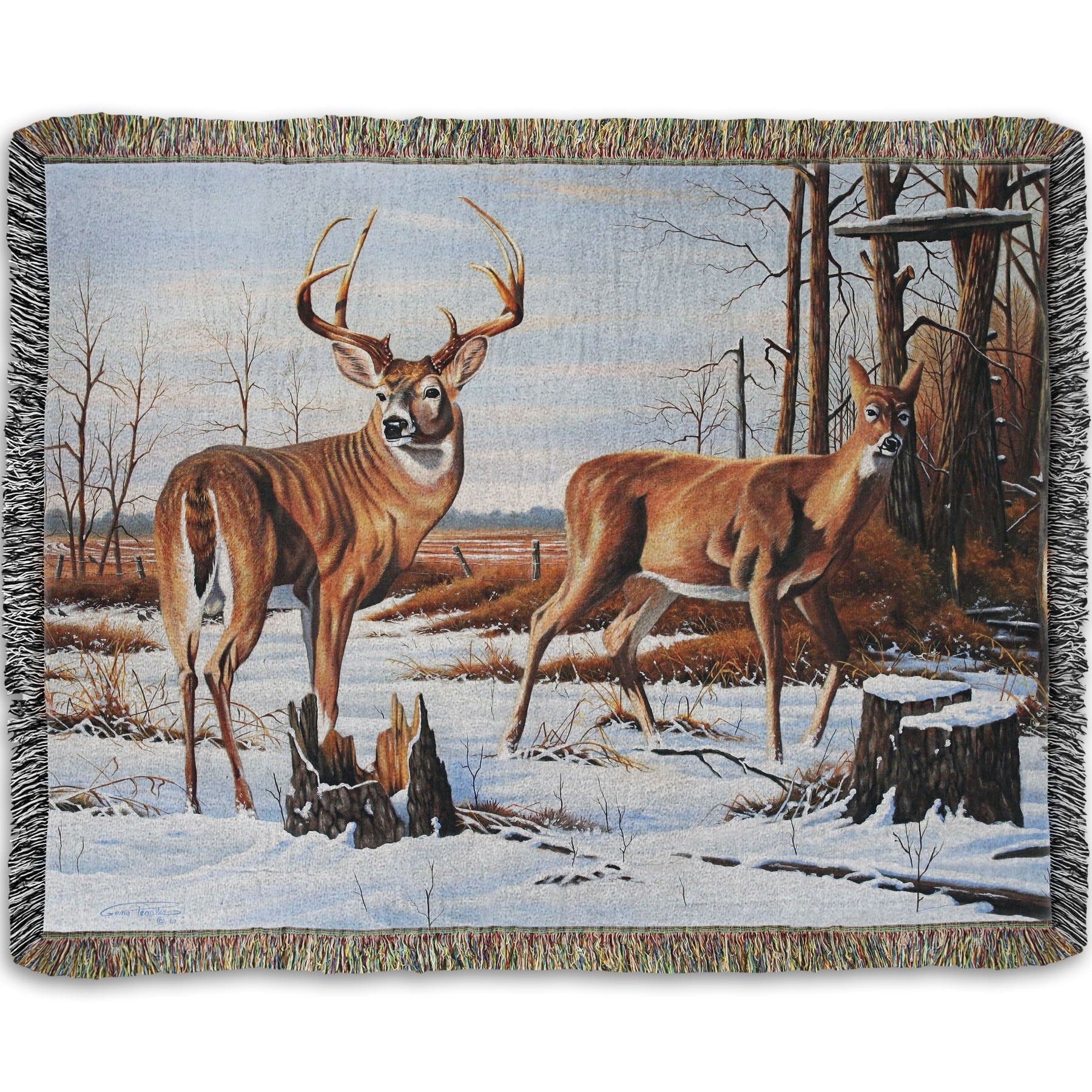 Woven throw blanket designed with deer walking through the snow between the woods and a field.