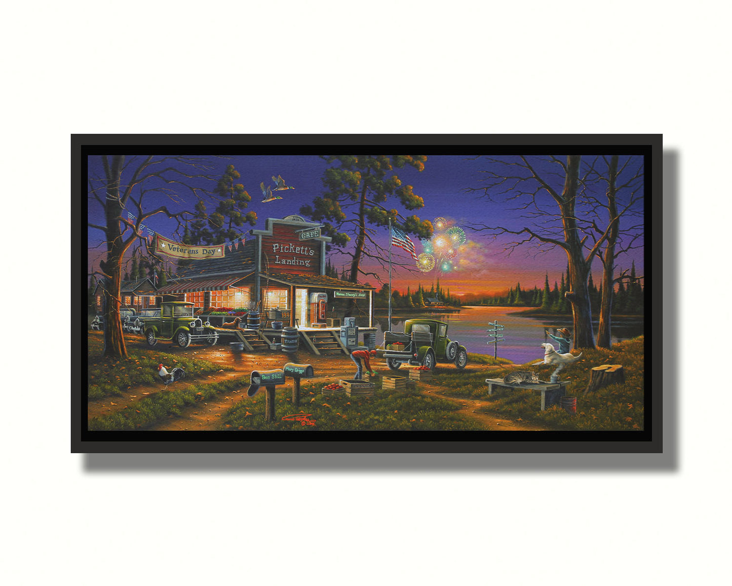 A landscape painting of a lakeside café at sunset, overlooking a colorful fireworks display over the lake on Veterans Day. People sit in the grass watching the excitement. Printed on canvas in a float frame.