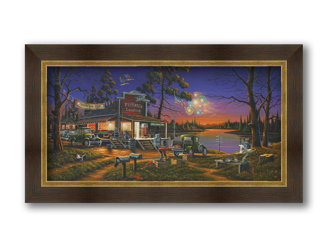 A landscape painting of a lakeside café at sunset, overlooking a colorful fireworks display over the lake on Veterans Day. People sit in the grass watching the excitement. Printed on canvas and framed.