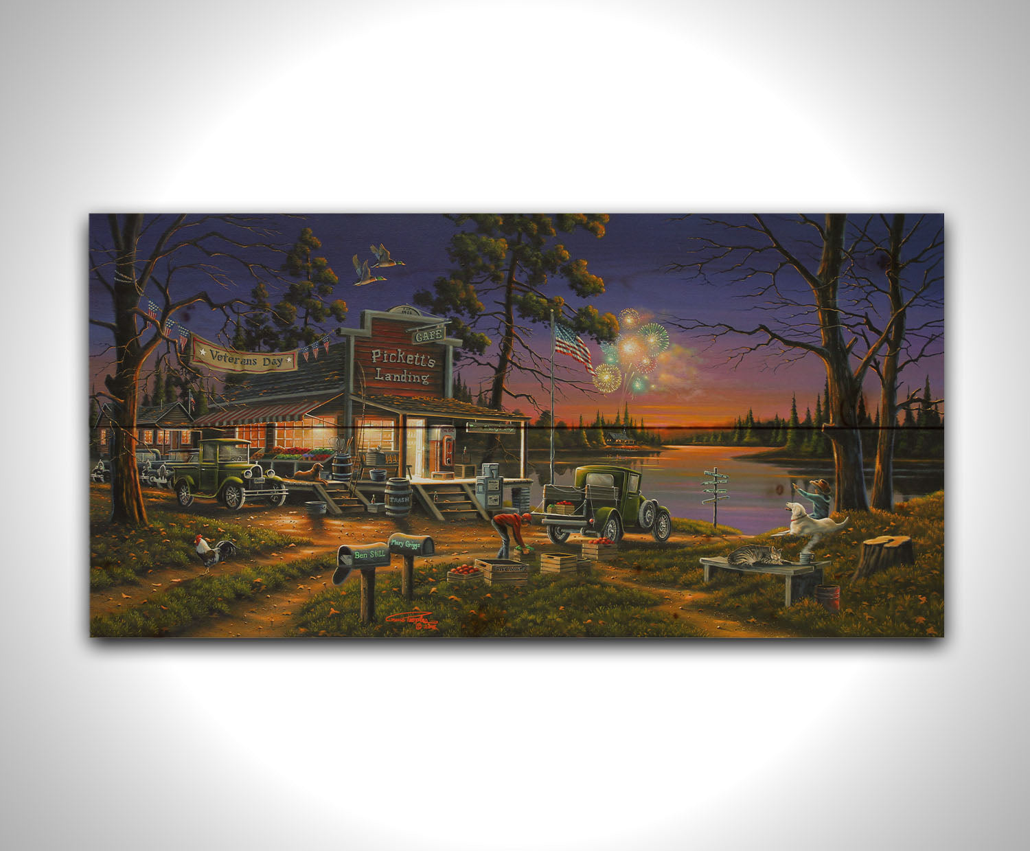 A landscape painting of a lakeside café at sunset, overlooking a colorful fireworks display over the lake on Veterans Day. People sit in the grass watching the excitement. Printed on a wood pallet.