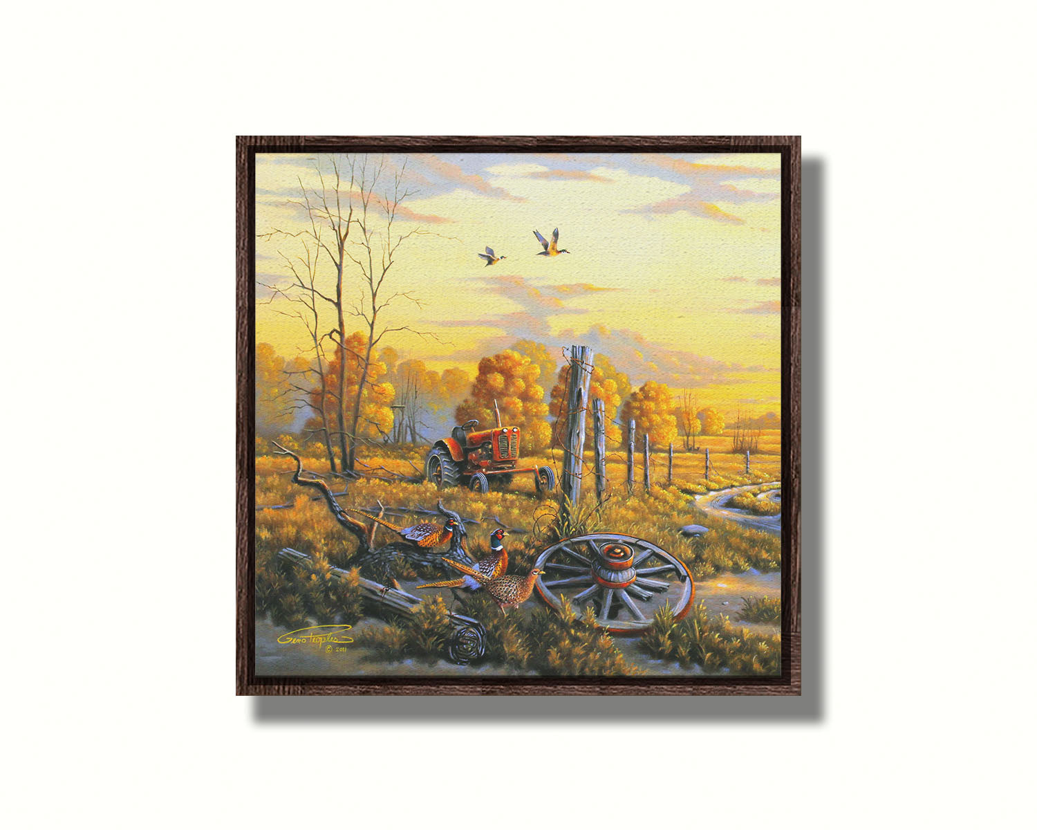 A landscape painting of autumn trees and a field. A tractor, a broken wheel, and a broken fence post add extra character to the scene. Pheasants sit in the foreground and ducks fly overhead. The sky and field are as golden yellow as the trees, in the morning light. Printed on canvas in a float frame.