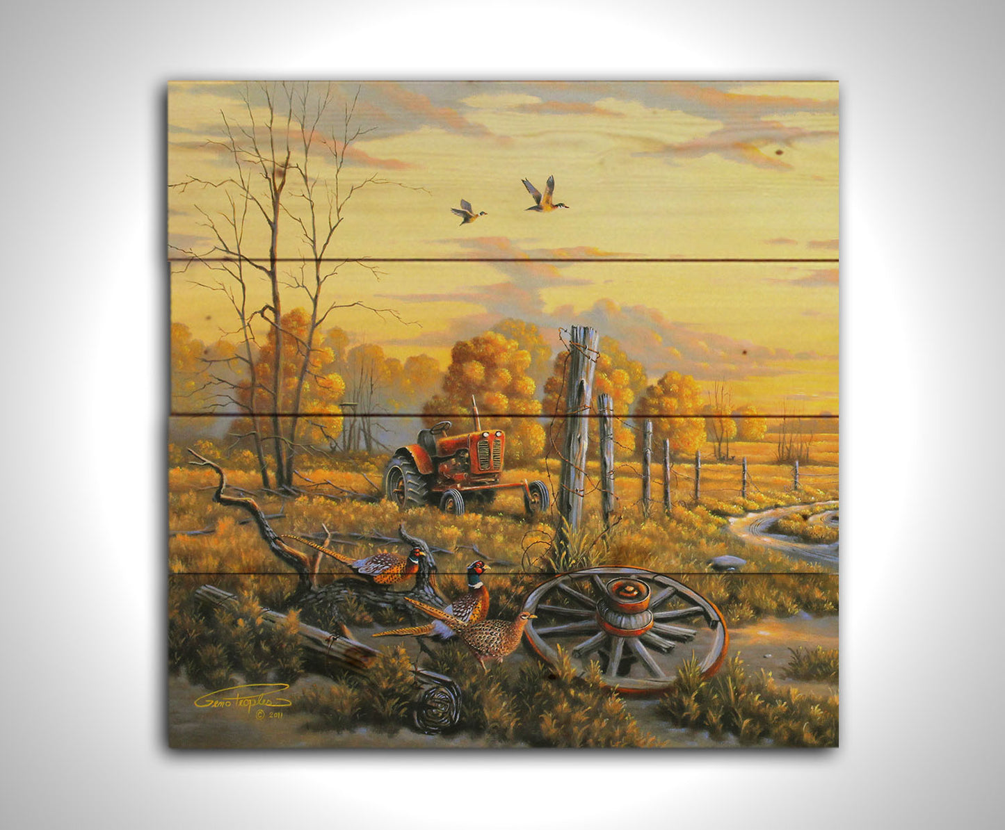 A landscape painting of autumn trees and a field. A tractor, a broken wheel, and a broken fence post add extra character to the scene. Pheasants sit in the foreground and ducks fly overhead. The sky and field are as golden yellow as the trees, in the morning light. Printed on a wood pallet.