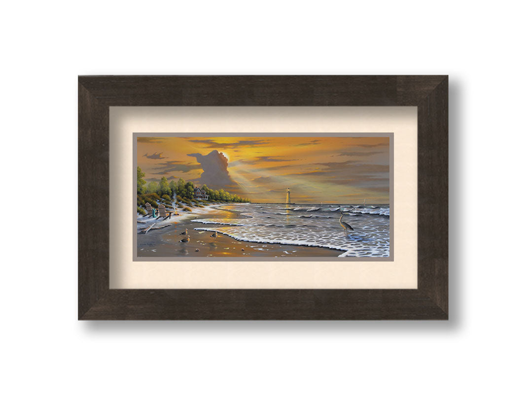 A painting of a beach scene, with a house and lighthouse in the distance. Birds trot along the sand, and the sun peeks from behind a cloud, shining beams of light down on them. Printed on paper, matted, and framed.