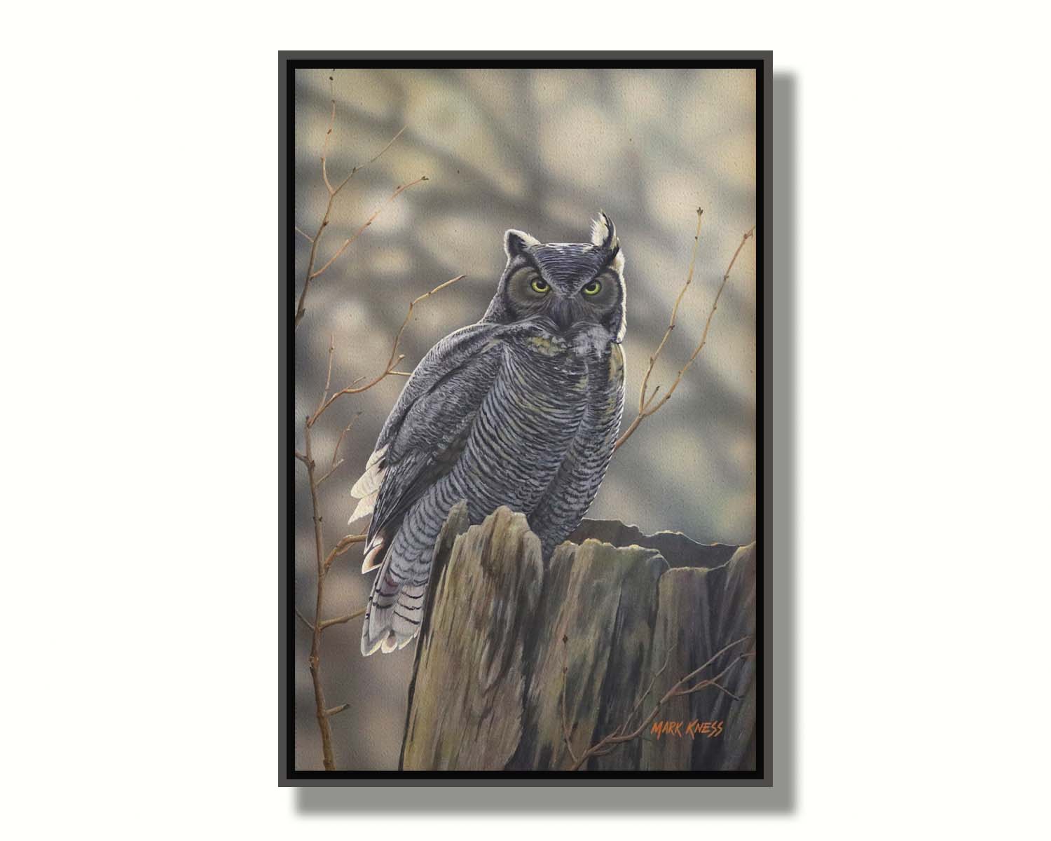 A painting of a great horned owl perched atop a log. Printed on canvas in a float frame.