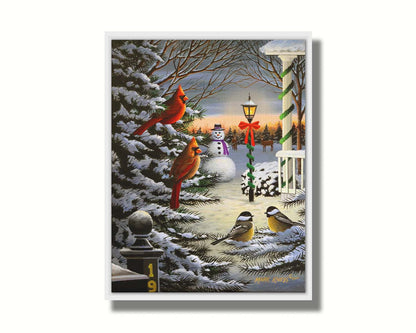 A painting of cardinals and chickadees perched on snowy evergreen branches. In the background, a festively decorated streetlamp illuminates a nearby snowman. Deer look on in the distance. Printed on canvas in a float frame.