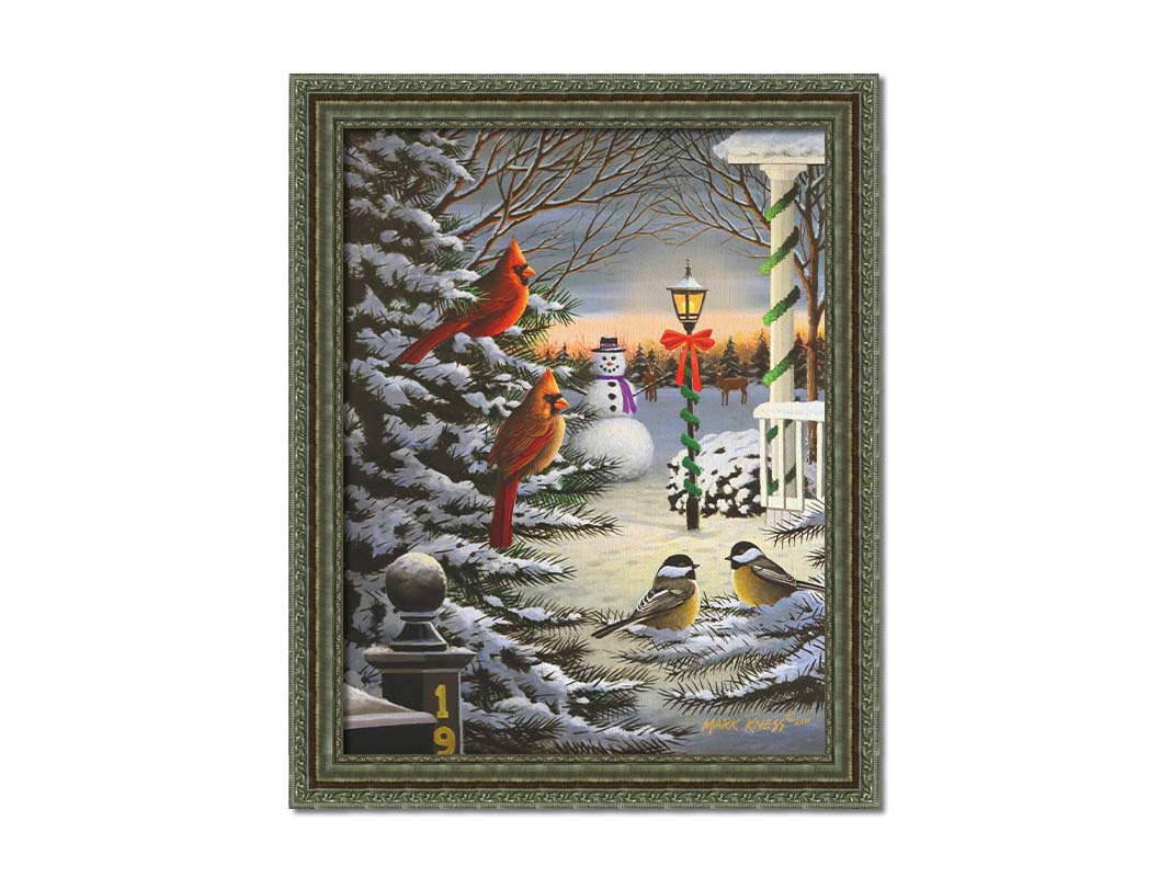 A painting of cardinals and chickadees perched on snowy evergreen branches. In the background, a festively decorated streetlamp illuminates a nearby snowman. Deer look on in the distance. Printed on canvas and framed.