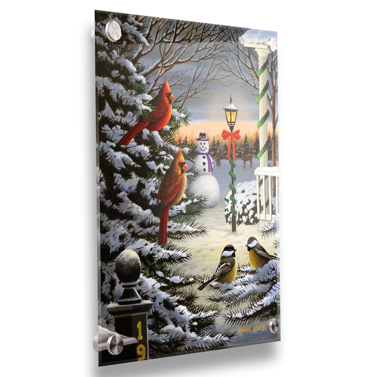 A painting of cardinals and chickadees perched on snowy evergreen branches. In the background, a festively decorated streetlamp illuminates a nearby snowman. Deer look on in the distance. Printed on acrylic.