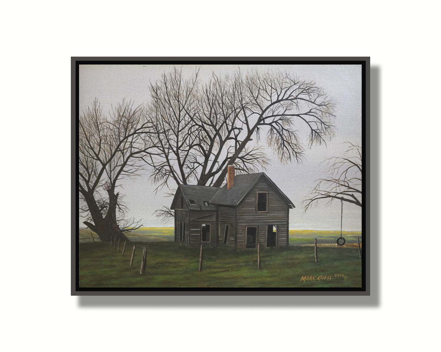 A painting of an old, abandoned house. There is a tire swing hanging on a bare tree in the yard, and the fields in the background are buried in fog. Printed on canvas in a float frame.