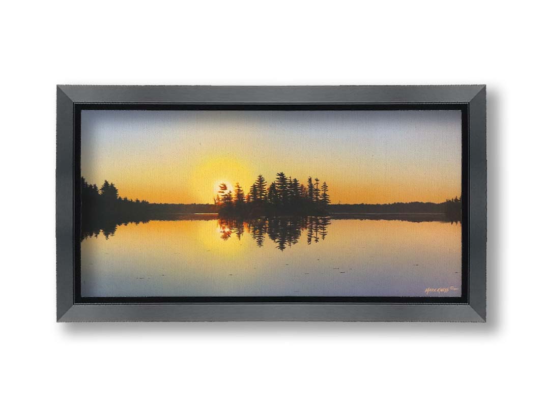 A painting of a low sun reflecting off the waters of a lake, surrounded by forest. Printed on canvas and framed.