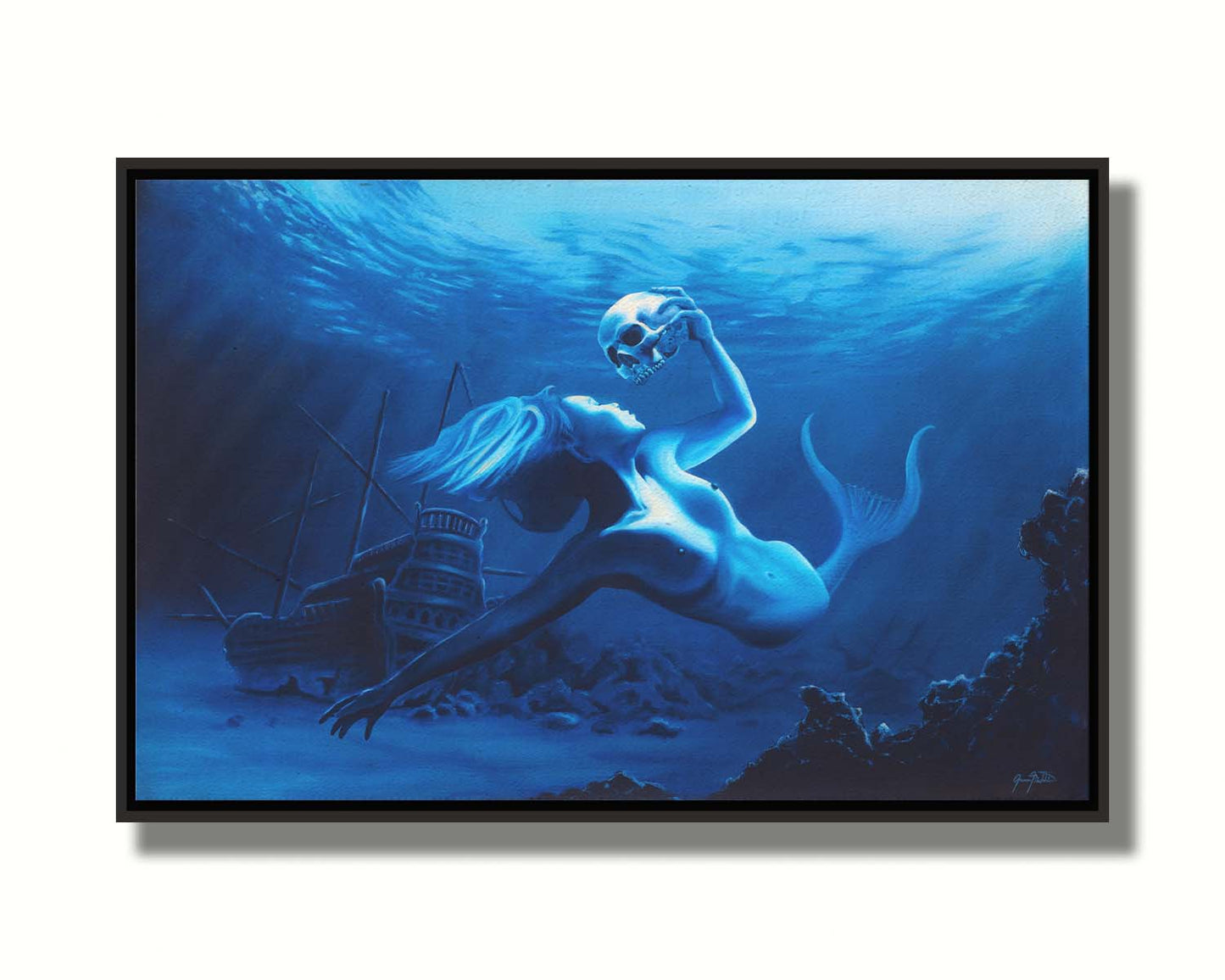 A monochrome blue painting of a mermaid near the seafloor, swimming through shipwrecks and carrying a human skull. Printed on canvas in a float frame.