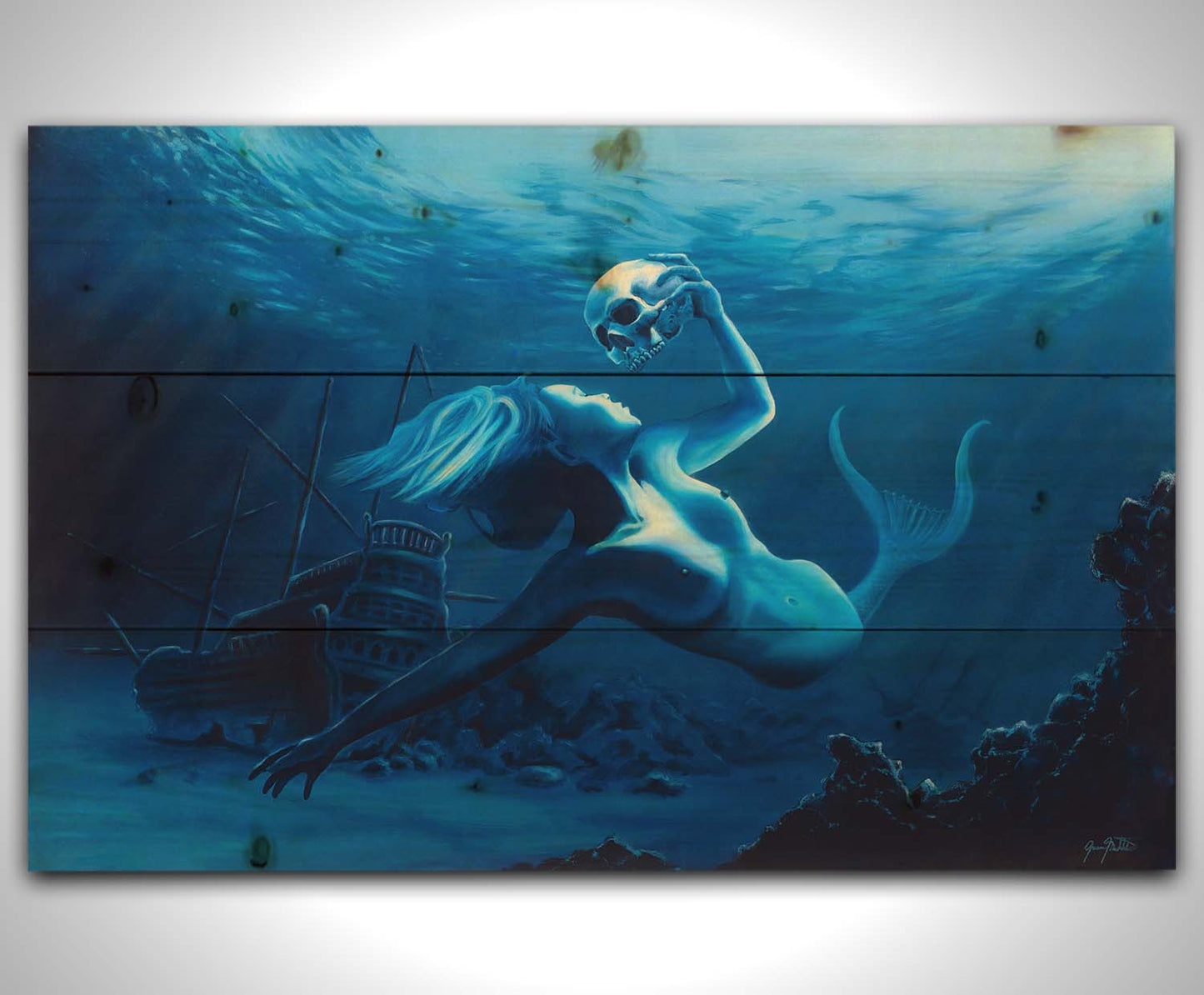 A monochrome blue painting of a mermaid near the seafloor, swimming through shipwrecks and carrying a human skull. Printed on a wood pallet.