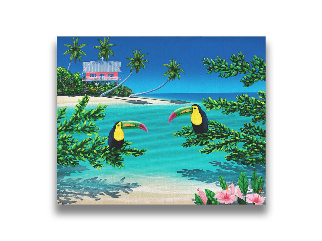 A vibrant painting of an island beach scene, featuring two toucans perched on plants in the foreground, and a bright house on stilt foundations in the background. Printed on canvas.