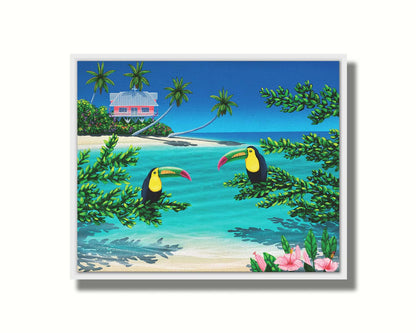 A vibrant painting of an island beach scene, featuring two toucans perched on plants in the foreground, and a bright house on stilt foundations in the background. Printed on canvas in a float frame.