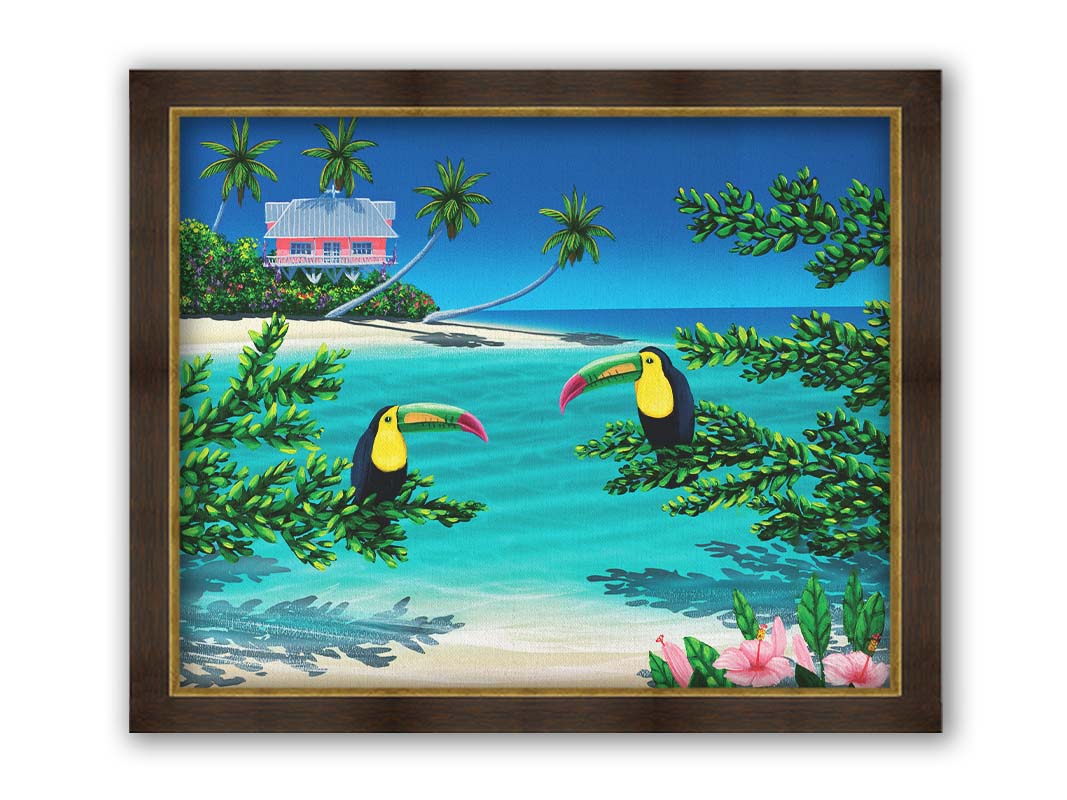 A vibrant painting of an island beach scene, featuring two toucans perched on plants in the foreground, and a bright house on stilt foundations in the background. Printed on canvas and framed.