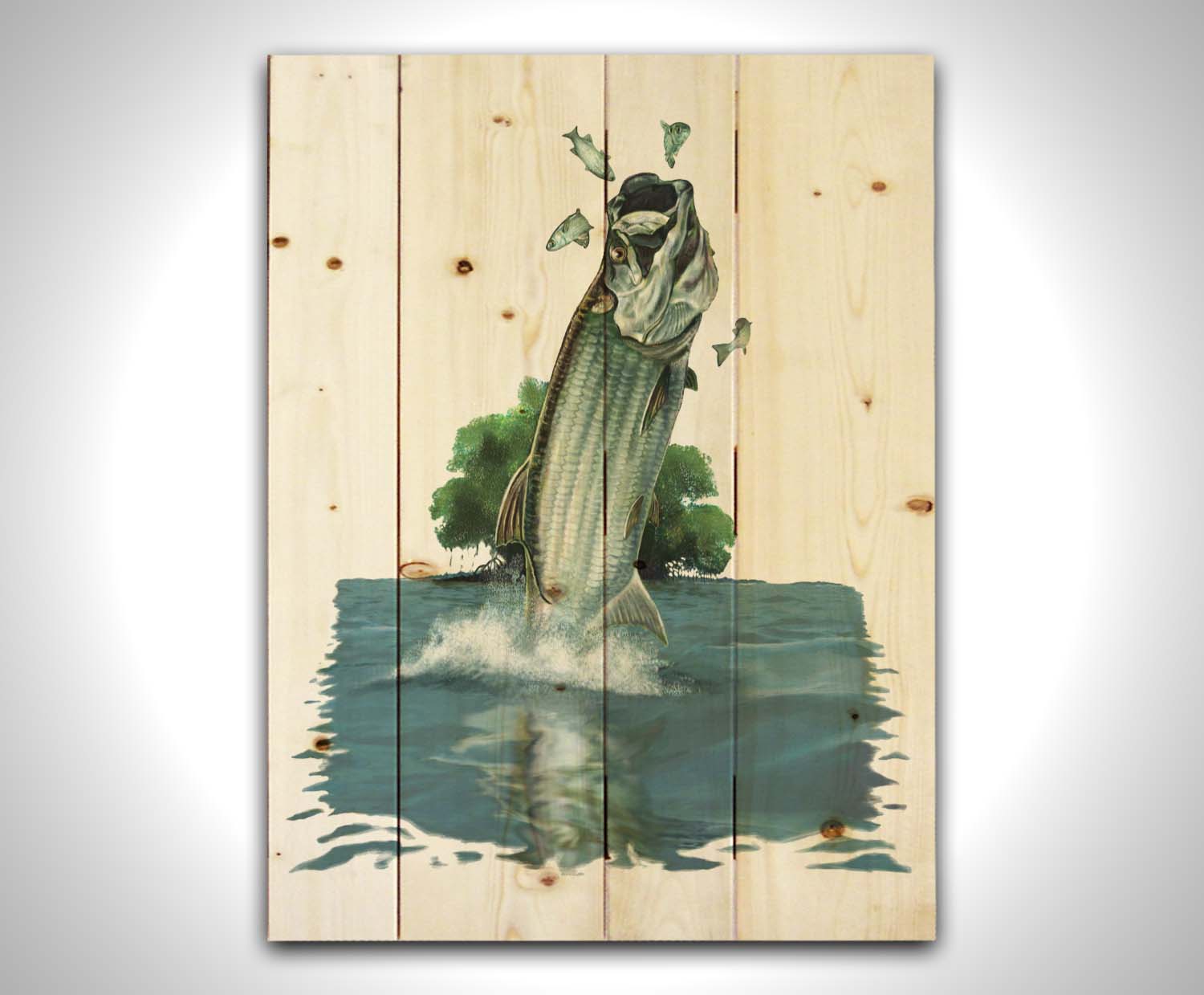 A painting of a tarpon fish leaping out of the water to catch and eat smaller fish. The fish, water's surface, and background tree are isolates against a white backdrop. Printed on a wood pallet.