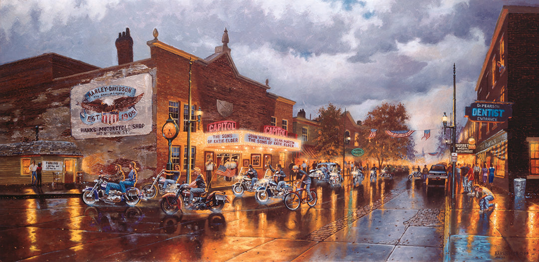 A painting of a group of bikers riding their motorcycles down a town road past a Harley Davidson motorcycle shop, a movie theater, and other shops. The sky is cloudy, and the shop lights reflect off the damp pavement.