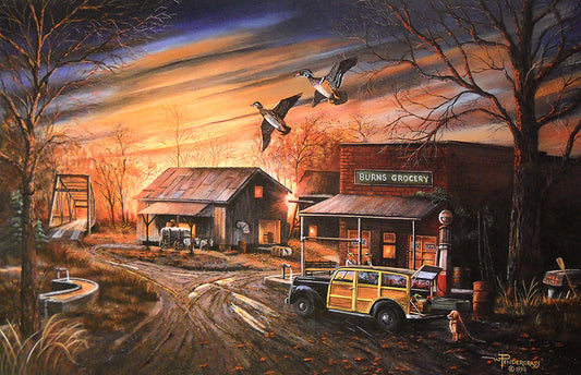 A rustic outdoor scene painting showing a small town with barns, a gas station, a vintage wood-paneled car, bare trees, and two wood ducks flying across the foreground against a dramatic orange and blue sunset sky.