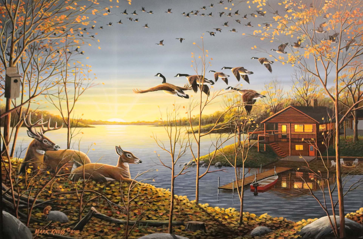 A painting of a lake scene by Mark Kness. Deer overlook a lakehouse as geese fly overhead at sunrise.