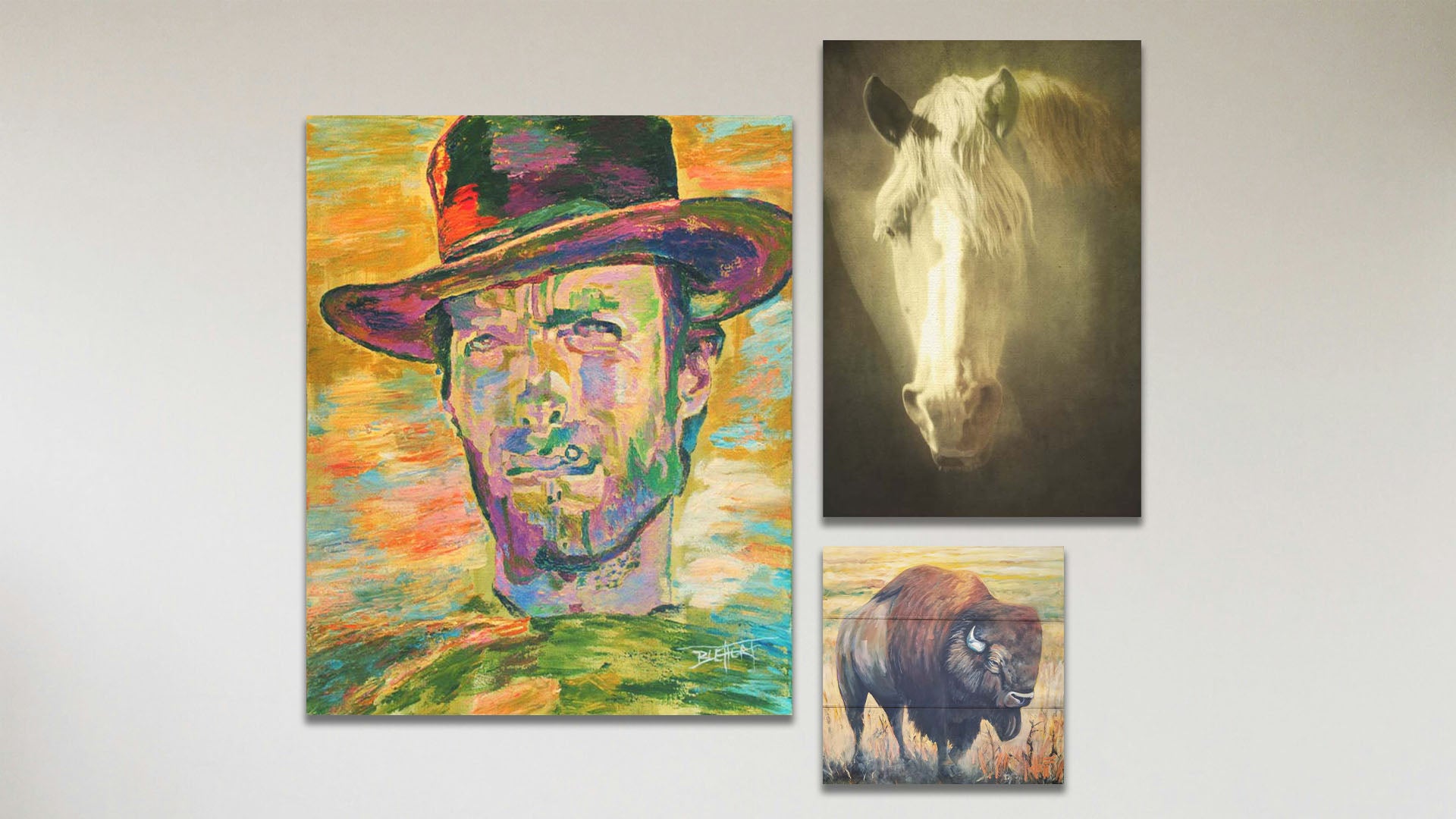 A collage of art in the standard Clint Eastwood package, including a canvas painting of Clint Eastwood, a canvas photograph of a sepia horse, and a box board painting of a bison.