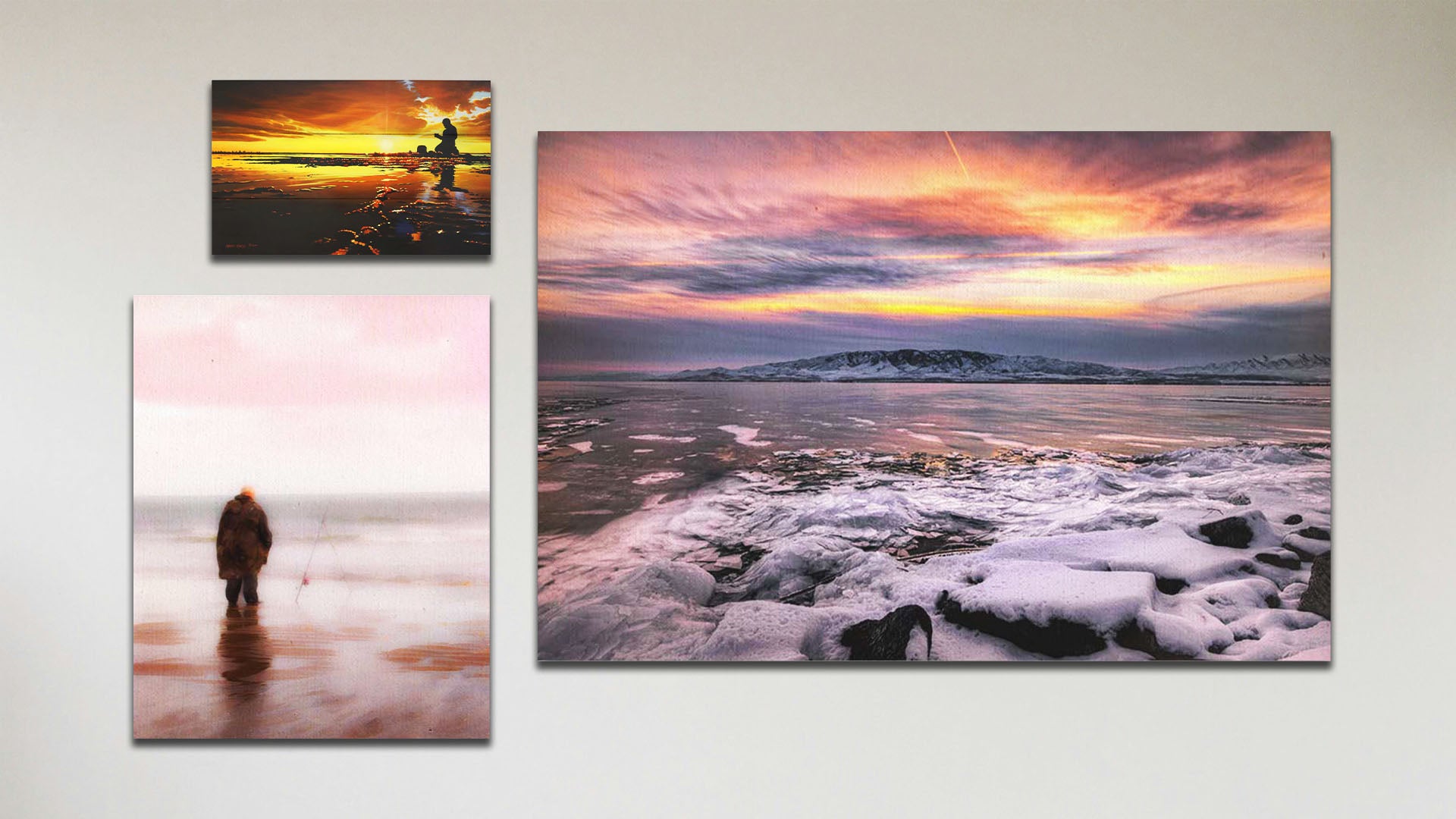 A collage of art in the standard Tranquil Harbor package, including a float framed photograph of a sunset over a snowy shore, a float framed photograph of a fisherman watching their line in the ocean shallows, and a matted and framed painting of a person fishing on an icy shore.