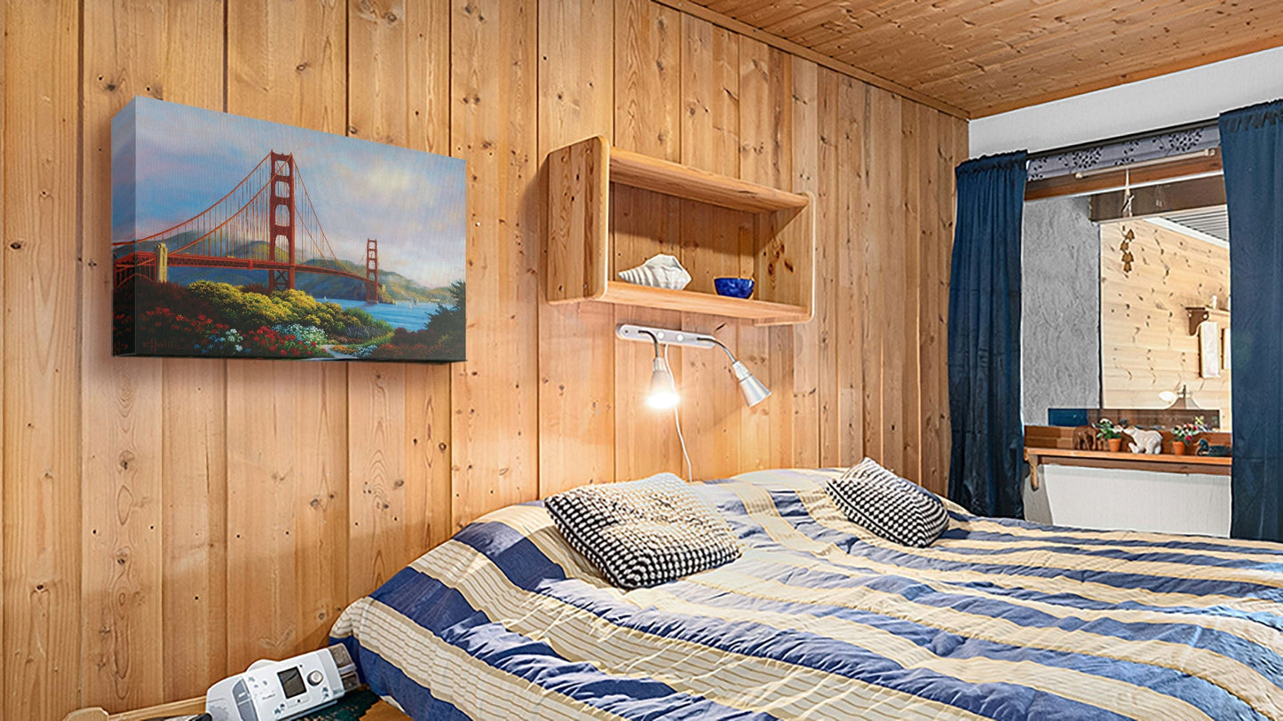 A seaside bedroom with light wood walls and blue and white furniture. A canvas painting of the Golden Gate Bridge in San Francisco, California, hangs on the wall.