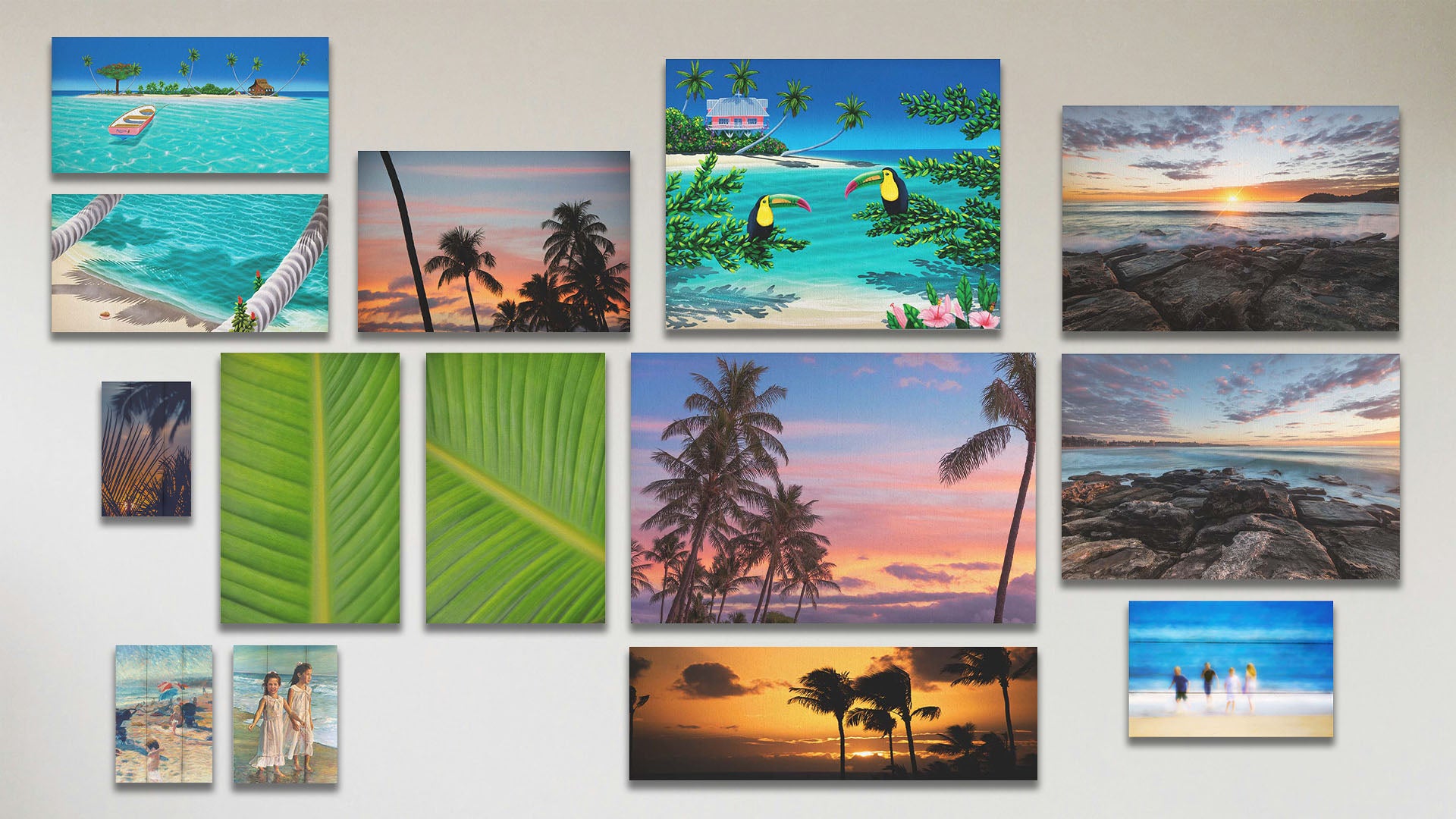 A collage of art in the standard Pastel Palms package, including two box board paintings of kids on the beach; two canvas photos of Manly Beach, Australia; two canvas photos of bird of paradise leaves; two box board photos of tropical plants silhouetted by the sunset and kids on the beach; three canvas paintings of an island beach, a rowboat at an island, and toucans perched on beach plants; two canvas photos of palm trees; and a canvas photo of a sunset in Maui.