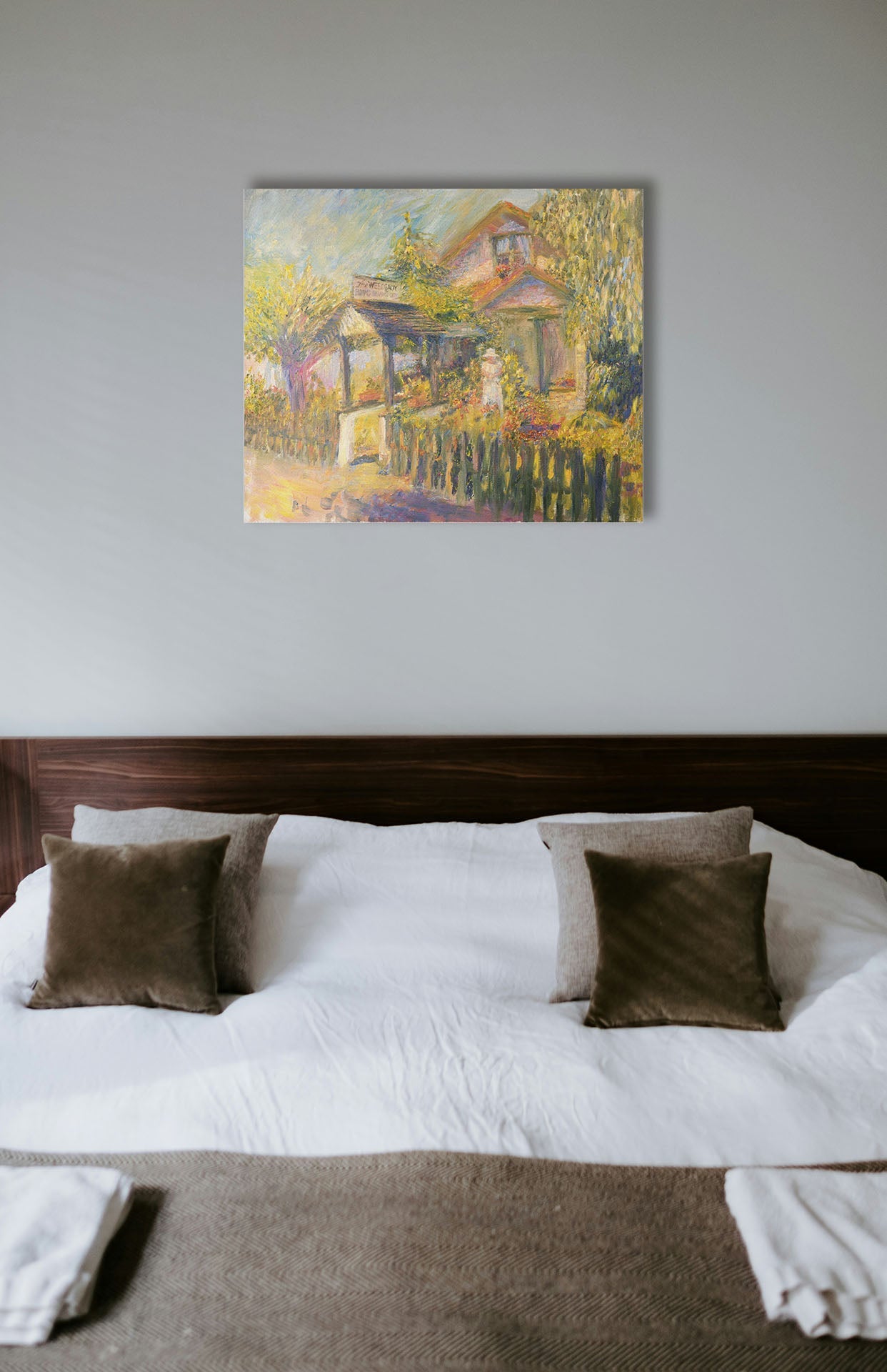 A typical bedroom with light walls and a cozy brown bed. A canvas painting of a garden store hangs on the wall.