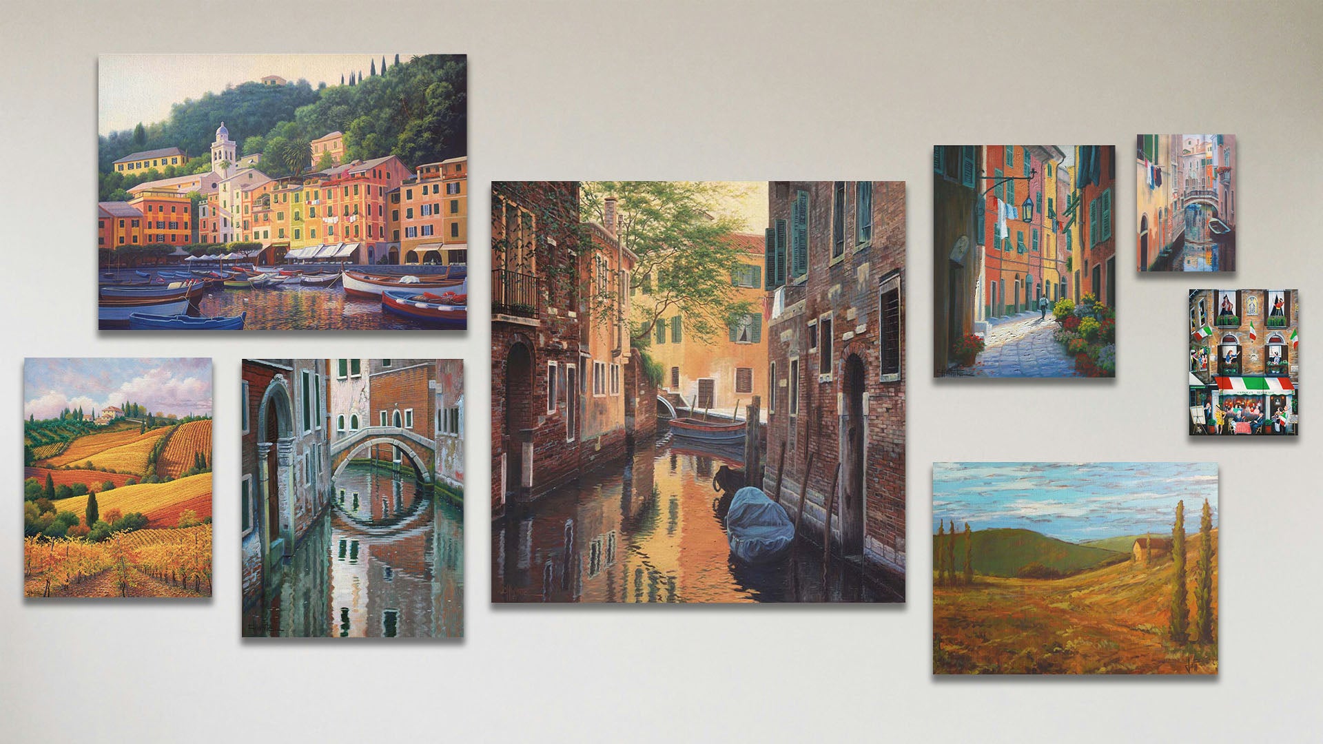 A collage of art in the luxury Venetian Back Alley package, including six canvas paintings of a bridge reflecting on the waters of a canal, colorful vineyards in Tuscany, boats docked in the city of Portofino, a streetlight over an alley, and a field in Tuscany; plus two box board paintings of an Italian community, and clothes hanging over a canal in Italy.