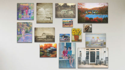 A collage of art in the standard Window to the Past package, including a box board photo of a hat on a chair; three box board paintings of a vase of sunflowers, a family lost on their road trip, and a family at a gas station; four canvas photos of a truck in a field, a farm house porch, and two barns; and six canvas paintings of a little town by the water, people on a bench, kids on a window, an old mill, a person walking their dog, and three kids walking.