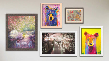 A collage of art in the designer Tangerine Dream package, including two framed paintings of colorful stylized bears, a framed painting of a garden blossoming with cherry trees, a framed photograph of cherry blossoms in Japan, and a matted and framed painting of butterflies.