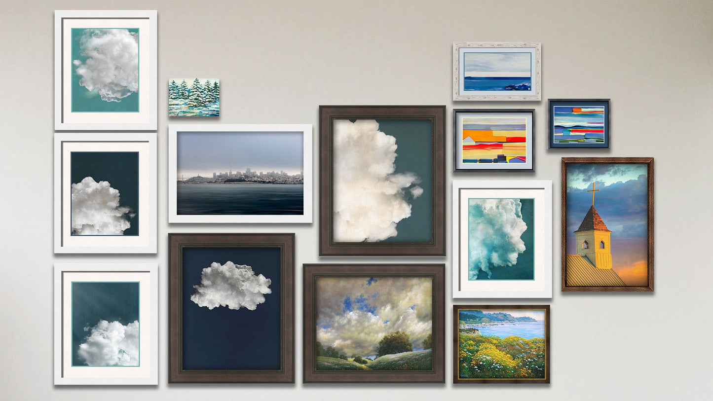 A collage of art in the designer Clouds package, including three matted and framed abstract paintings invoking sea and field landscapes, four matted and framed photographs of clouds, two framed photographs of clouds, a framed painting of the cloudy sky over a green hill, a framed painting of cliffside greenery above the sea, a canvas painting of snowy evergreens, a framed photograph of the San Francisco skyline, and a framed photograph of a church at sunset.