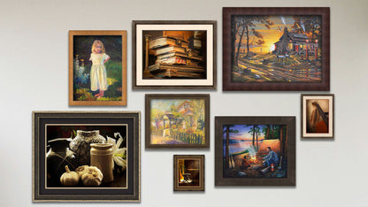 A collage of art in the designer Crack of Dawn package, including four framed paintings of an old lakeside gas station, people camping at sunset, a garden store, and a child in a garden; two matted and framed photos of old books and pottery; and two matted and framed photos of an old guitar and a dining chair.