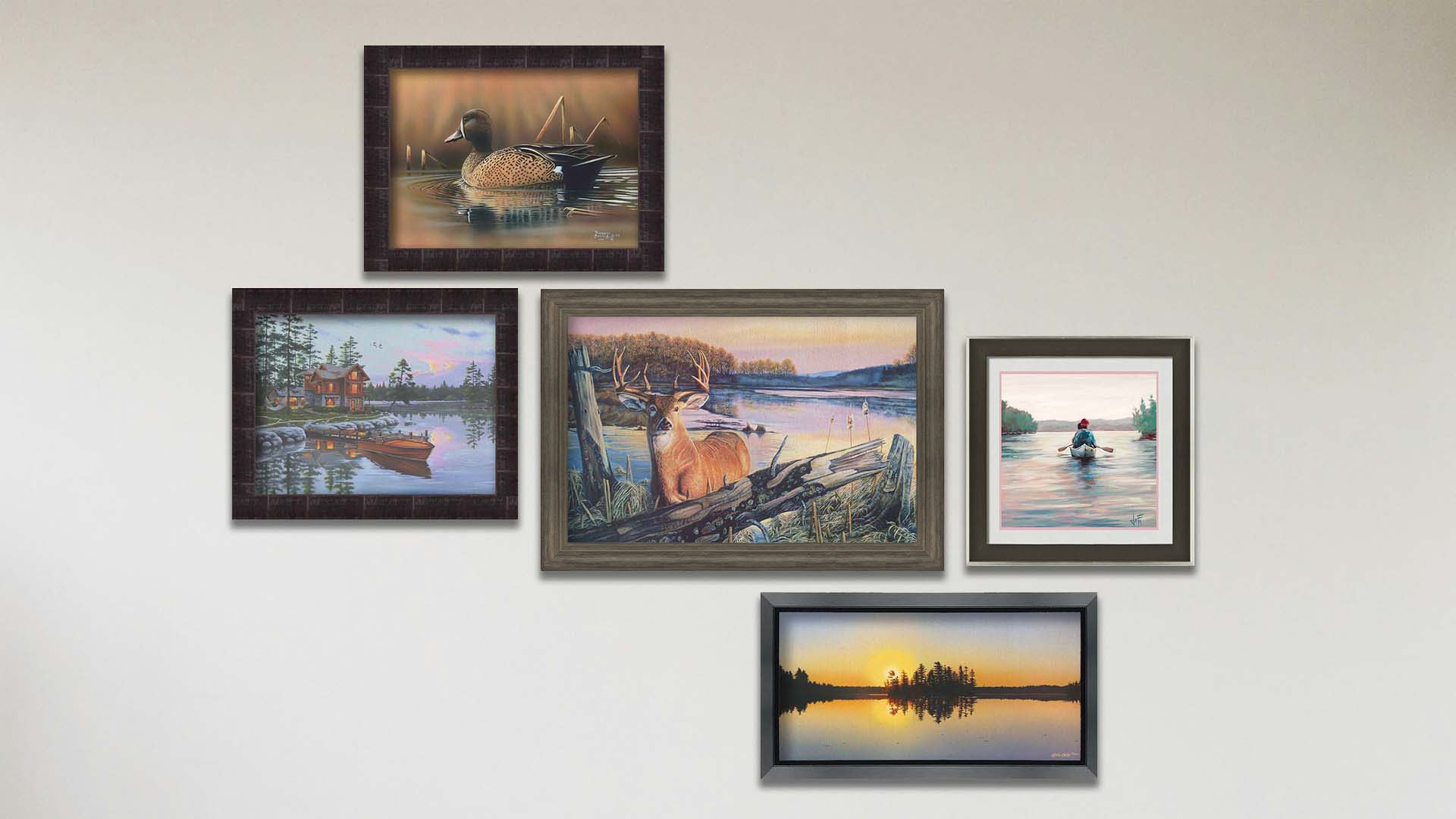 A collage of art in the designer By Dawn's Early Light package, including a framed painting of a deer standing in a lake at sunrise, a framed painting of a blue-winged teal swimming in a brown scene, a framed painting of a lakeside cabin and docked rowboat, a framed painting of a calm lake reflecting the low sun, and a matted and framed painting of people paddling a canoe across a lake on a peaceful, misty morning.