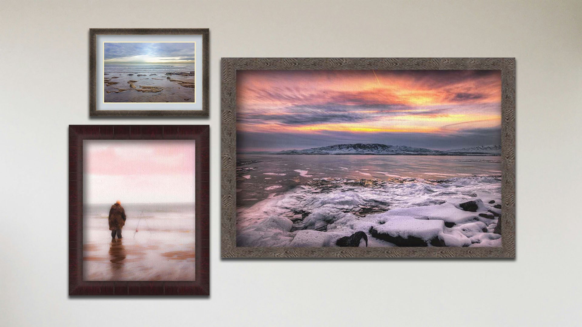 A collage of art in the designer Tranquil Harbor package, including a float framed photograph of a sunset over a snowy shore, a float framed photograph of a fisherman watching their line in the ocean shallows, and a matted and framed painting of a person fishing on an icy shore.