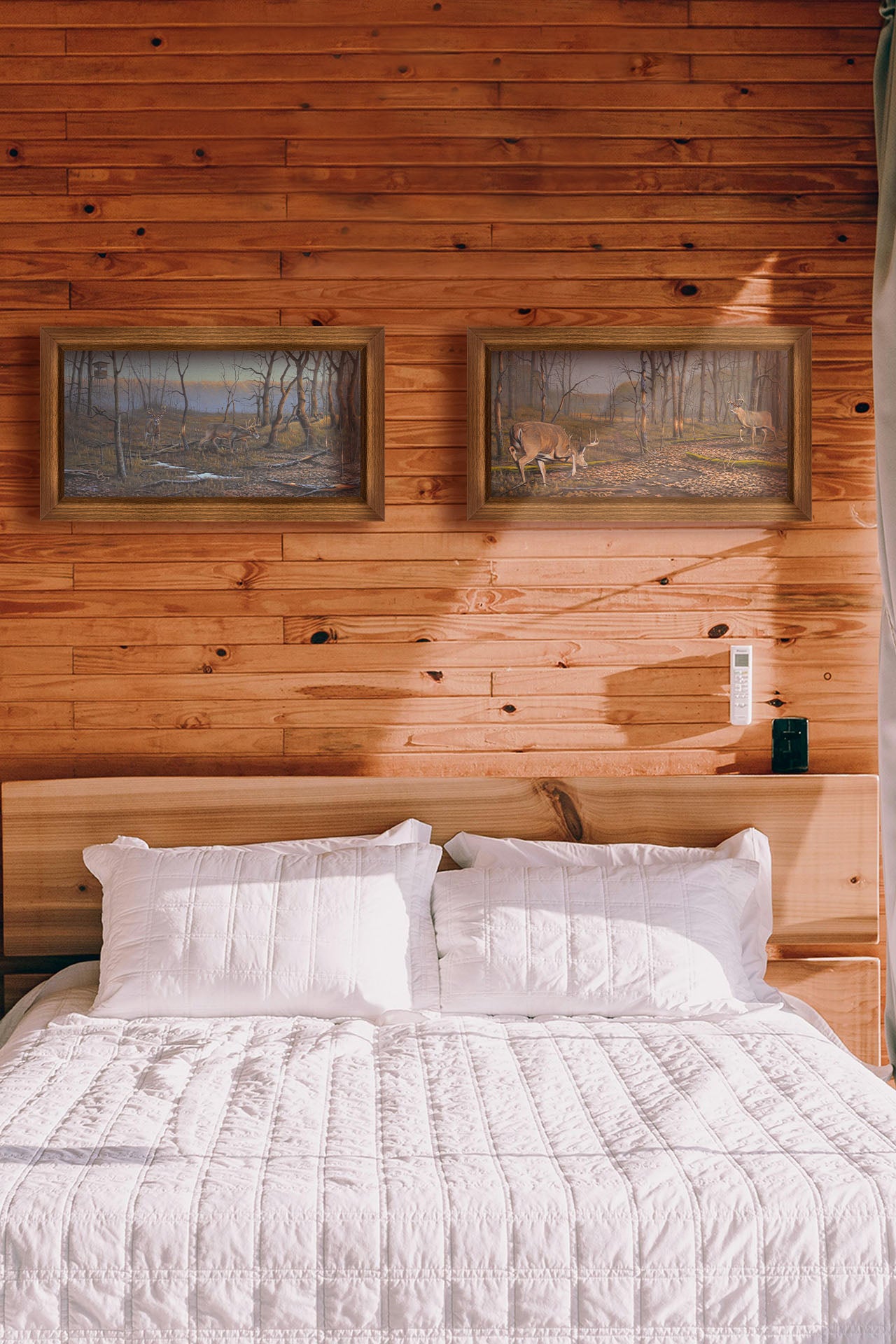 Two paintings hang on a bedroom wall. The first is a painting of deer walking through the forest in winter, with turkeys wandering through the background. The trees are bare, and brown leaves cover much of the ground. Hunting stands can be seen in the distance. Printed on canvas and framed. The second is a painting of two deer approaching each other in the woods. The two bucks are about to fight, as is evident by their body language. Printed on canvas and framed.