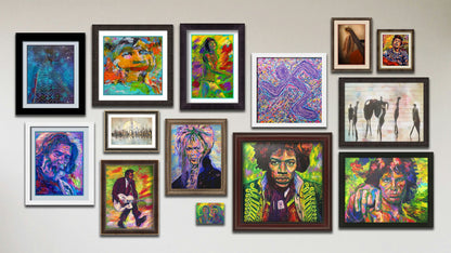 A collage of art in the designer music package, including four matted and framed paintings of Jerry Garcia, Mick Jagger, Bob Dylan, and a contemporary portrait; three matted and framed photographs of a city skyline, a dreamy skyscraper in the night sky, and a guitar; five framed paintings of David Bowie, Jim Morrison, Jimi Hendrix, Chuck Berry, and a contemporary running figure; a framed photograph of dancing figures; and a canvas painting of John Lennon with Paul McCartney.