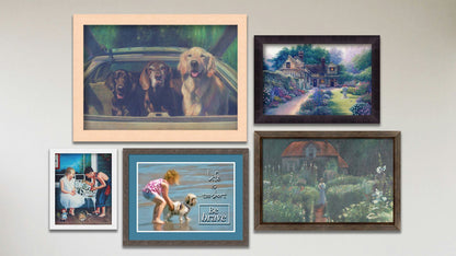 A collage of art in the designer Summer Days package, including a framed painting of a little house surrounded by a garden, a framed painting of a large courtyard garden, a framed painting of three dogs riding in the back of a car, a framed painting of two children looking at bugs on a porch, and a matted and framed photo of a child and dog on the beach overlaid with the phrase "Life is too short, be brave."