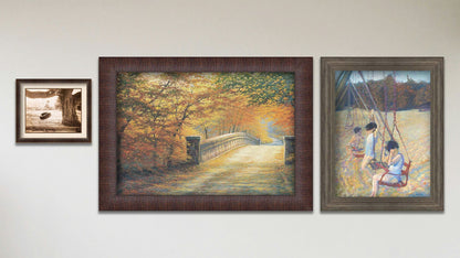 A collage of art in the designer Swingers package, including a framed painting of children playing on a swing set, a framed painting of a road through an autumn forest, and a matted and framed sepia photo of a tire swing hanging from a broad tree.